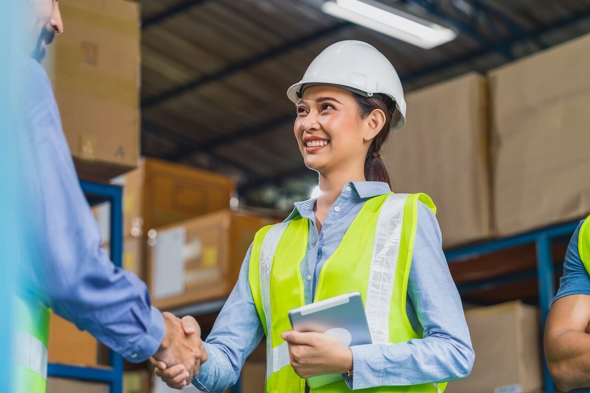 manager of warehouse worker hand shake with assist