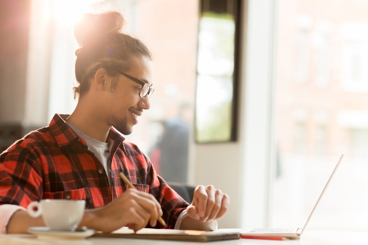 smiling man watching a webinar