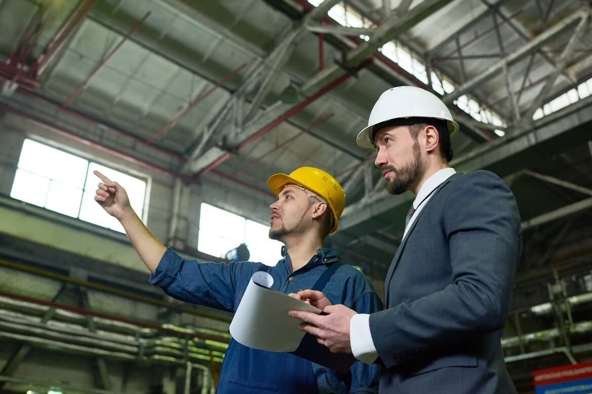 two male engineers at work in a warehouse setting