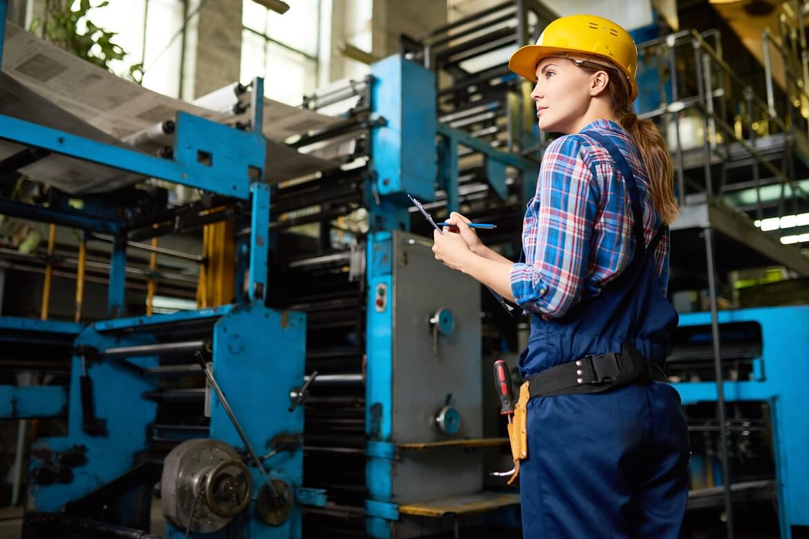 Young woman taking inventory in a manufacturing plant