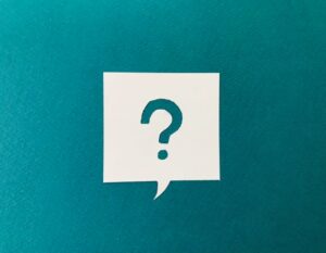 Question mark in speech bubble on teal background