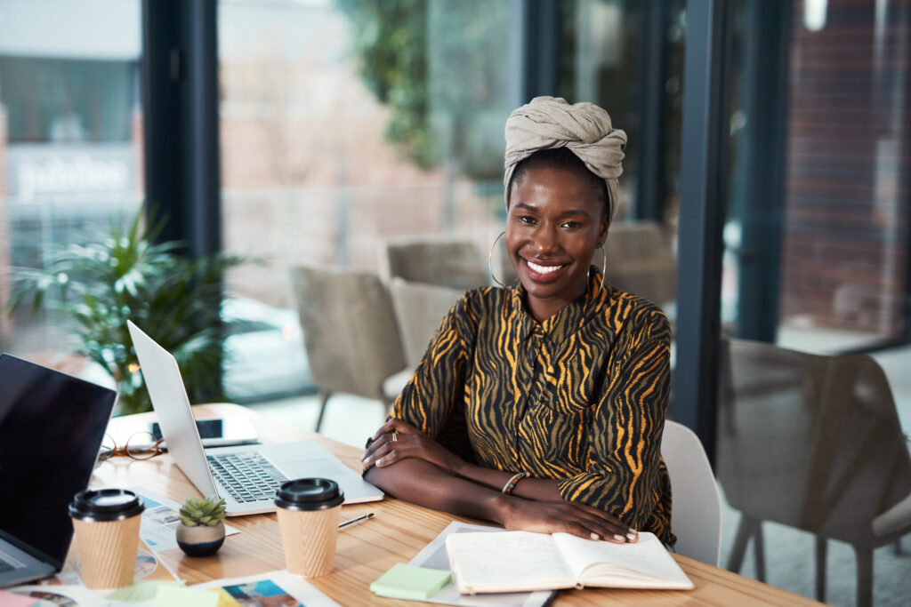 Smiling woman sitting at a desk.