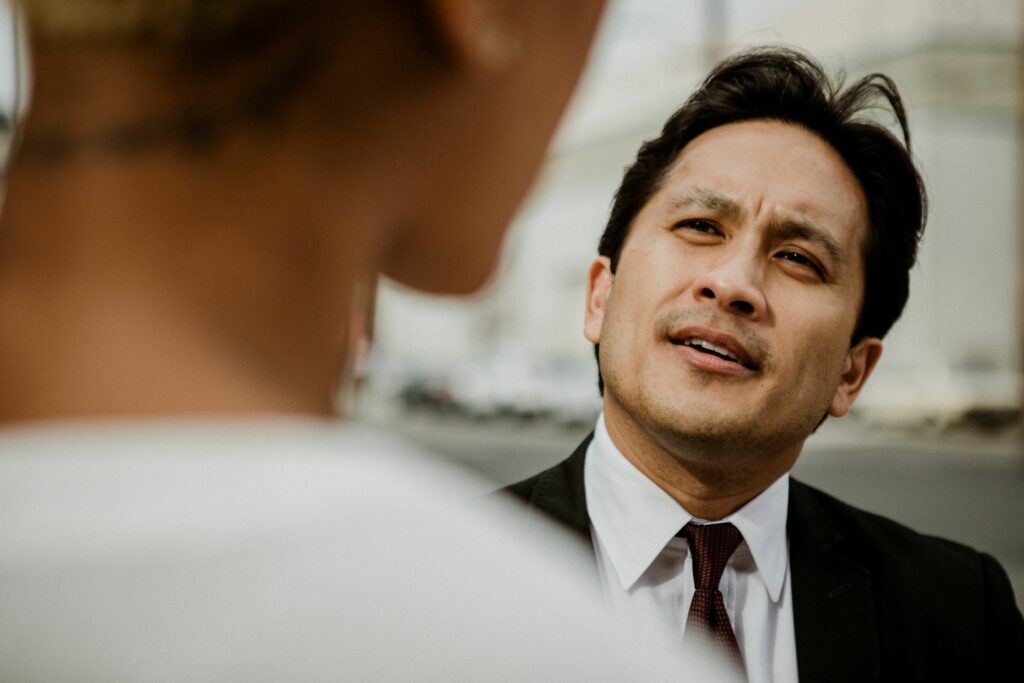 Man in suit and tie looking thoughtful.