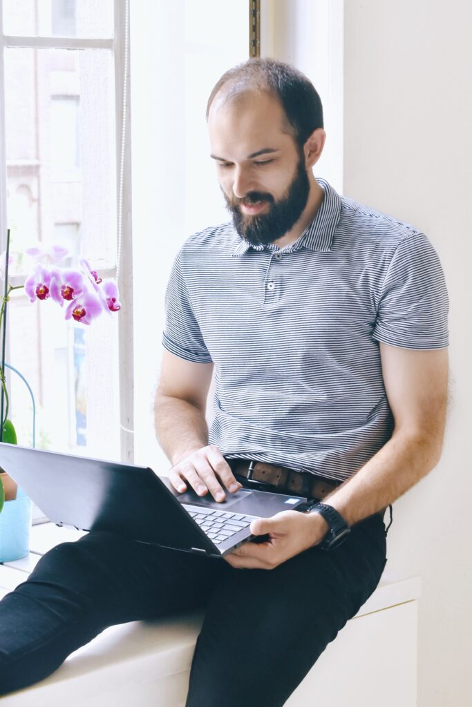 sitting man using a laptop